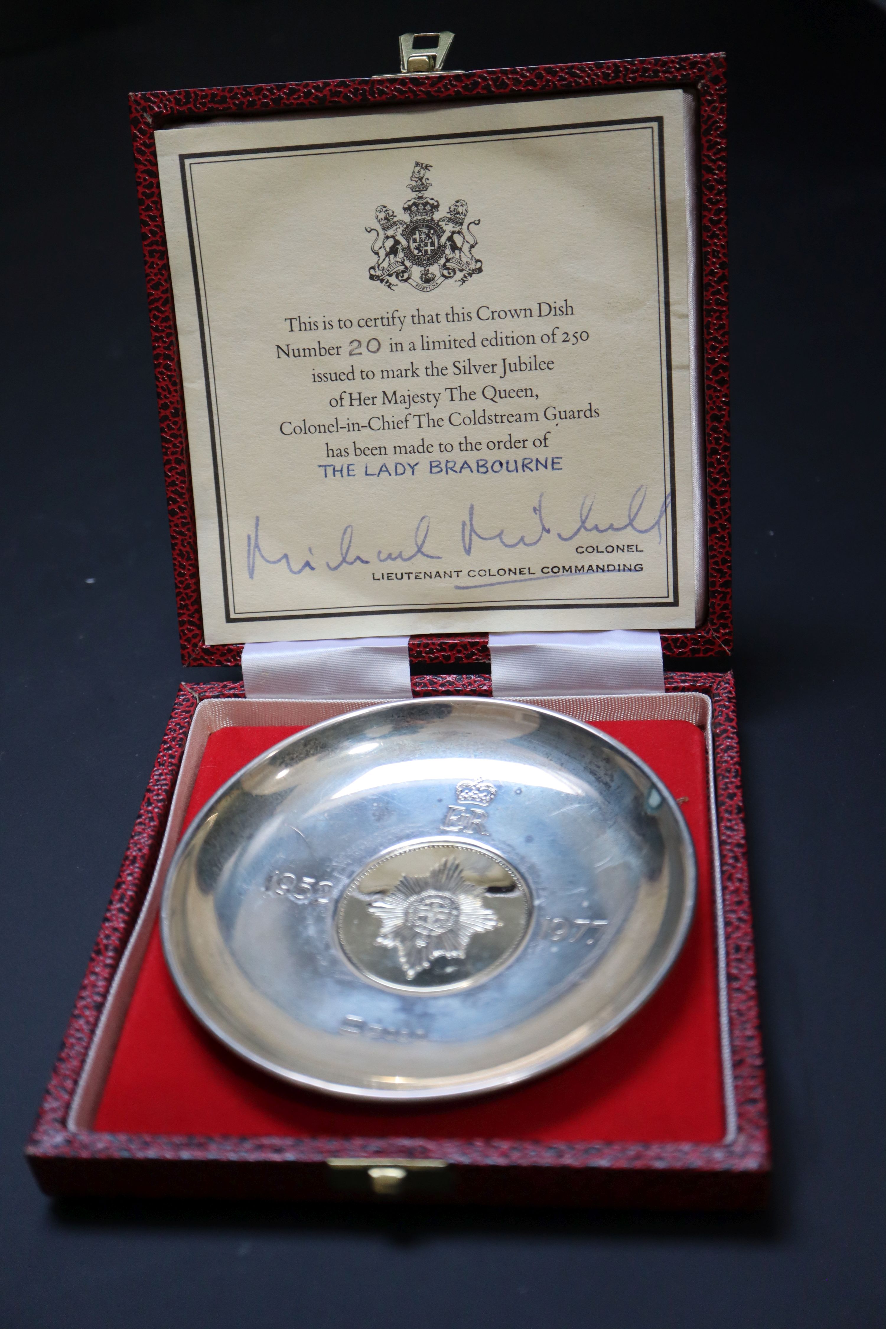 A Queen Elizabeth Silver Jubilee Coldstream Guards commemorative silver armada dish, diameter 10.15cm, cased, gross 79 grams.